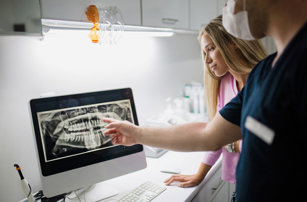 Dentist evaluating digital xrays
