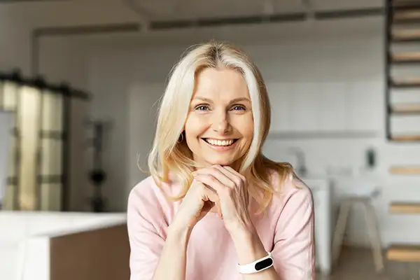 Smiling woman sitting in room with teeth whitening treatment from San Francisco Dental Arts in San Francisco, CA