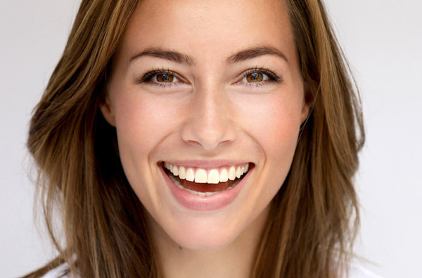 Beautiful woman smiling after dental bonding procedure at San Francisco Dental Arts 