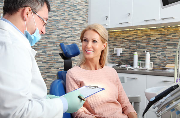 Woman talking to dentist during dental exam from San Francisco Dental Arts in San Francisco, CA