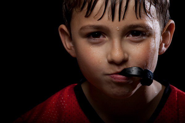 Sweaty boy with mouth guard in his mouth